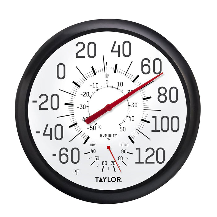 Close up of a 13.25 inch black and white thermometer and hygrometer with bold numerals and a red pointer.