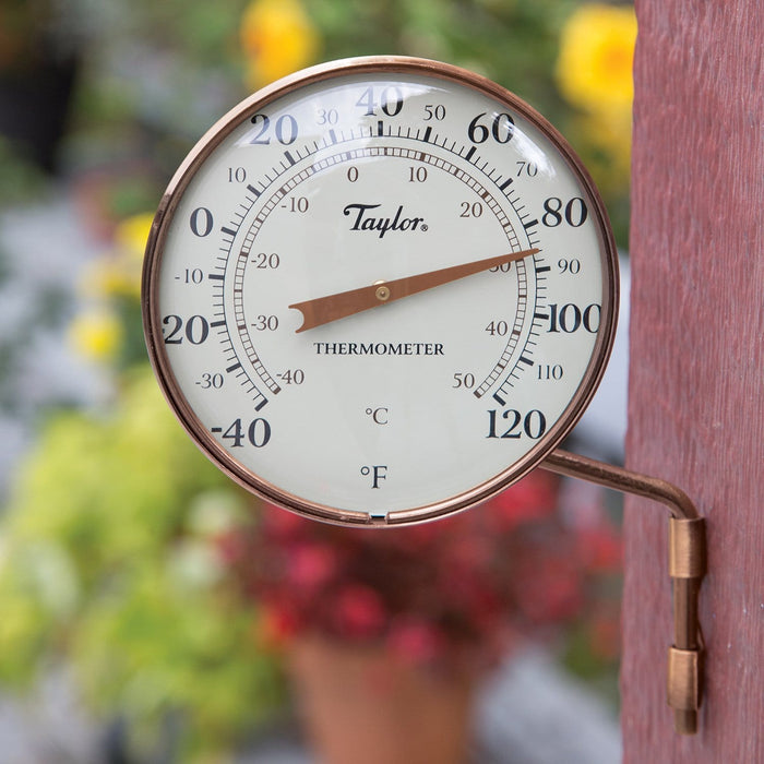 Taylor 4.25 inch Weatherproof Thermometer mounted on a wooden post outdoors