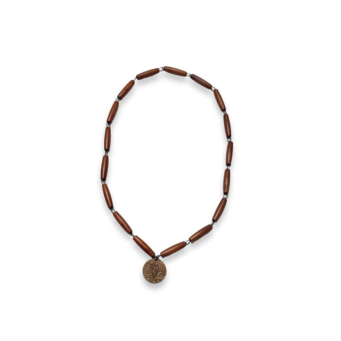 Bead rosary necklace with dark brown elongated beads and circular gold medal pendant