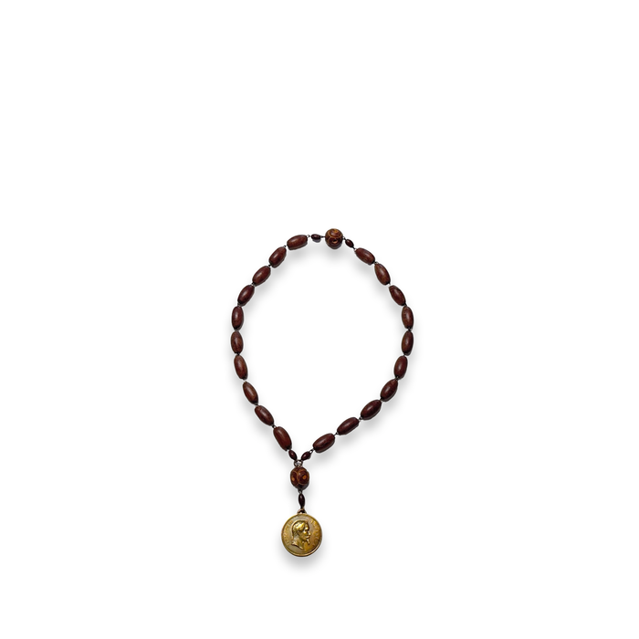 Brown bead rosary necklace with gold-tone medal pendant and small connector detail