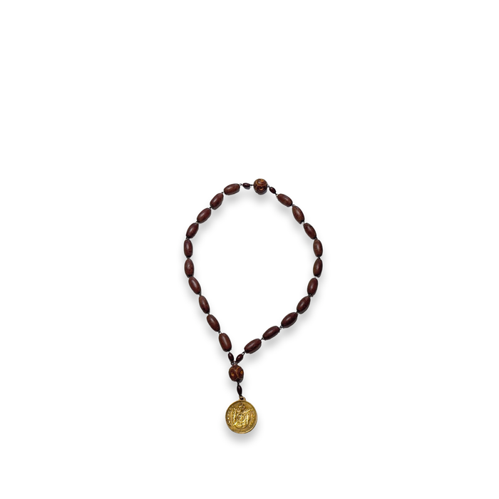 Brown beaded rosary necklace with gold medallion pendant and small red bead accent