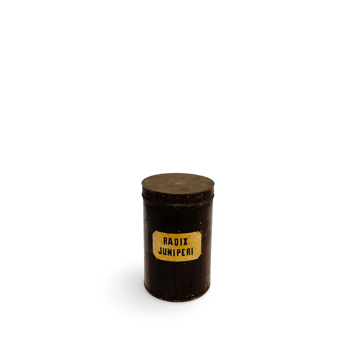Dark brown antique pharmacy canister with round lid and label reading RADIX JUNIPERI