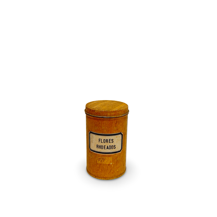 Golden antique pharmacy canister with round lid and label reading FLORES RHOEADOS