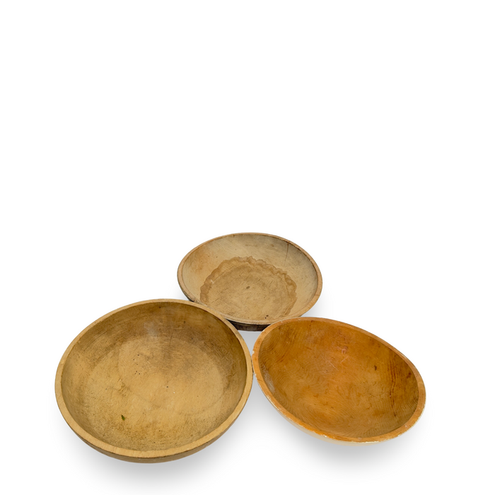 Set of three antique wooden bowls in tan, brown, and amber finishes