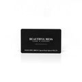 Beautiful Mess Home gift card, black with gold logo and text