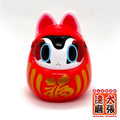 Folktoy Kaiju INUHARI-DARUMA “Red” by Teresa Chiba, a 10cm sofubi figure, features cartoon eyes, pointed ears, and gold kanji for “fortune.”