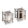 The Han Spice Jewels Set Salt & Pepper by L'Objet features square shakers with metal frames, 24k gold-plated tops, and clear bodies to display contents—elegantly packaged in a luxury gift box.