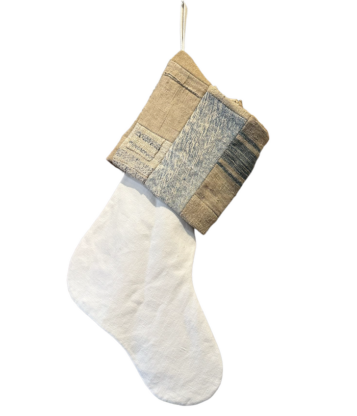 Patchwork fabric Christmas stocking with white body and woven cuff, hanging loop