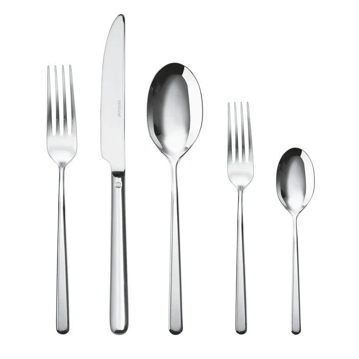 The Sambonet Linear Solid Handle Flatware 5 Place Setting includes a dinner fork, knife, soup spoon, salad fork, and teaspoon in stainless steel with sleek, polished handles and a modern design arranged side by side.