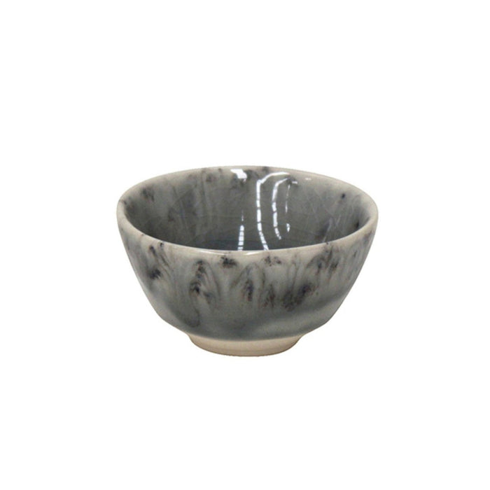 The Costa Nova Madeira Grey Dinnerware features a handcrafted small ceramic bowl with a gray and black marbled pattern, slightly flared rim, glossy finish, and short round foot, shown against a white background.