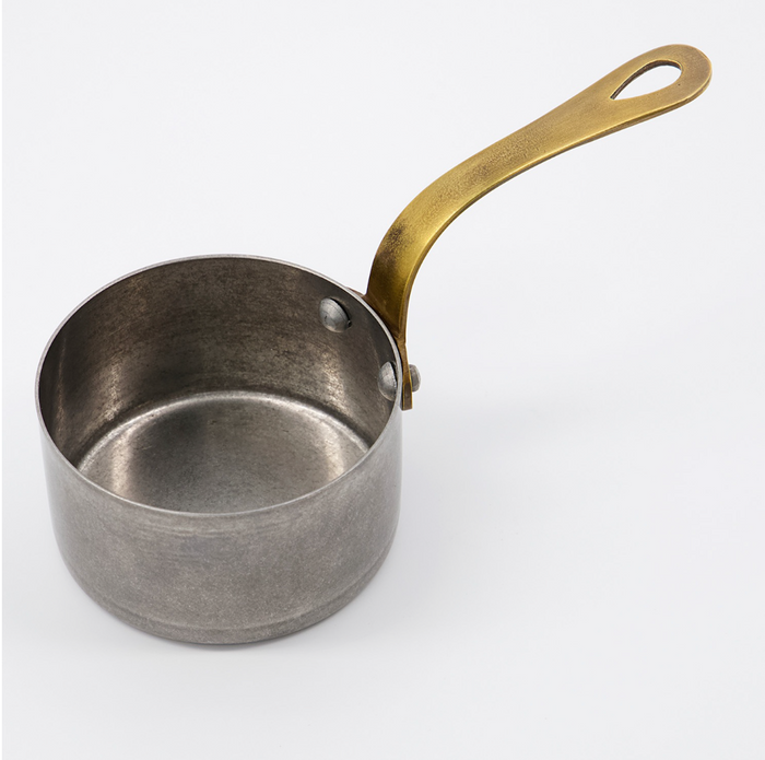 Small metal sauce pan with gold handle, round rim and side loop handle