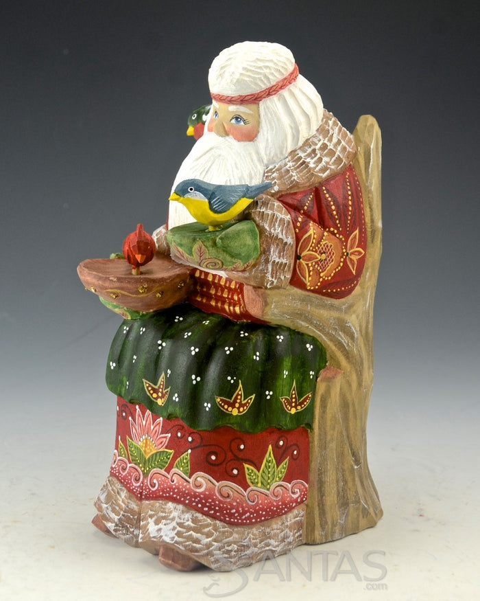 Peaceful Russian Santa Carving Feeding Several Birds