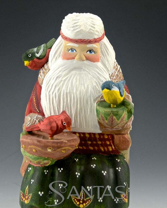 Peaceful Russian Santa Carving Feeding Several Birds