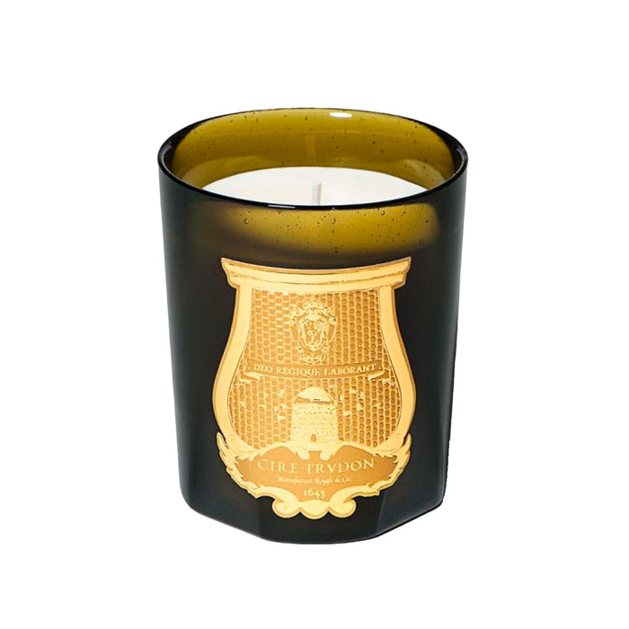 Scented candle in dark glass jar with gold crest label